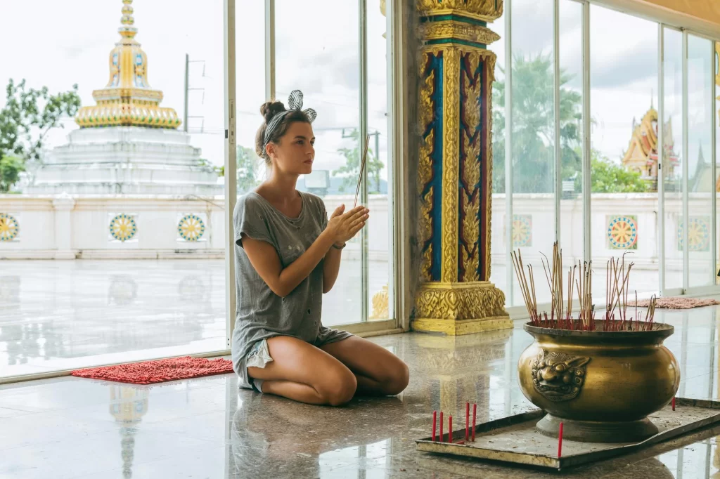 Woman praying in full devotion.