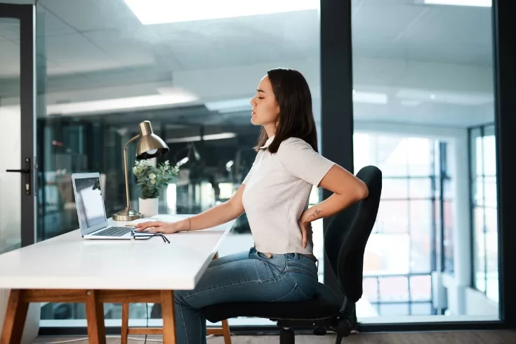 The woman started having back pain due to continuous sitting on the chair.