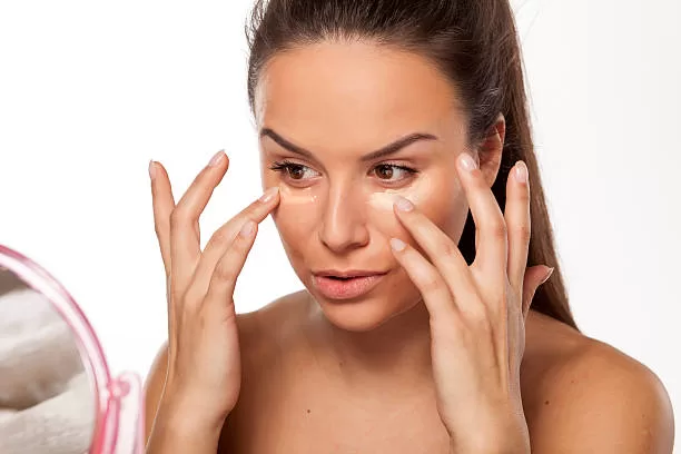 woman applying makeup Primer