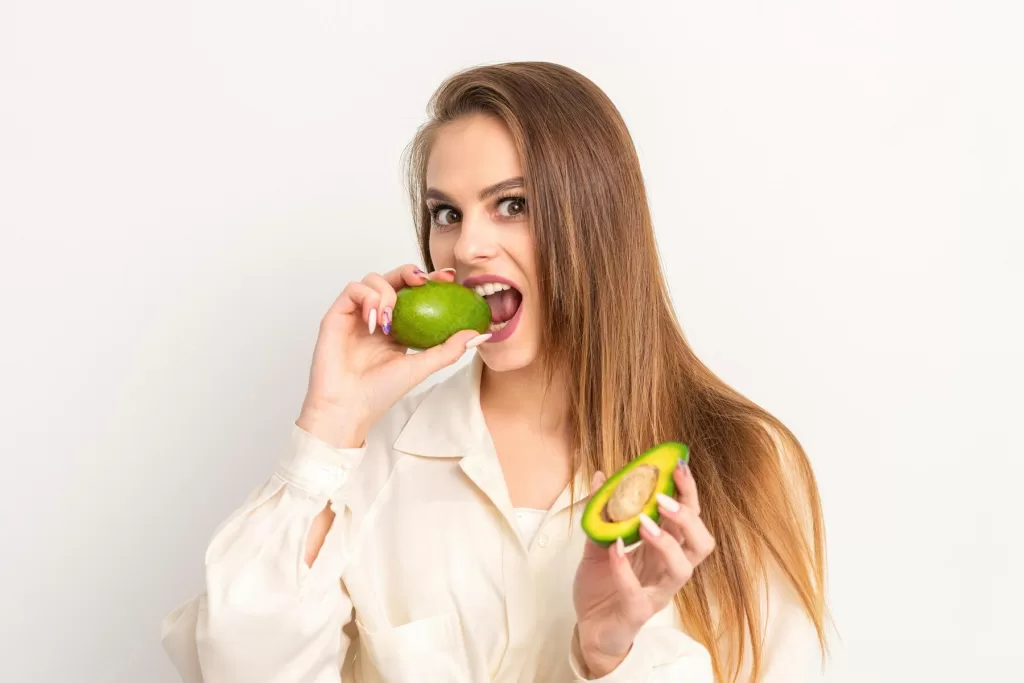 Girl relishing Avocado