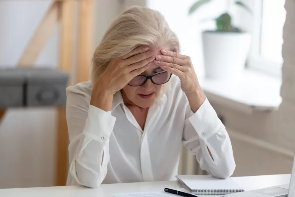 woman experiencing menopause at her workstation