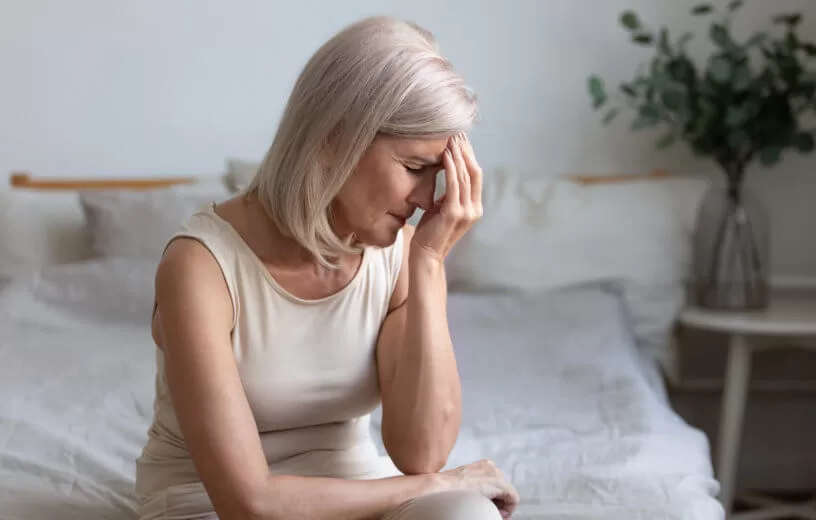 woman experiencing menopause at  home troubled