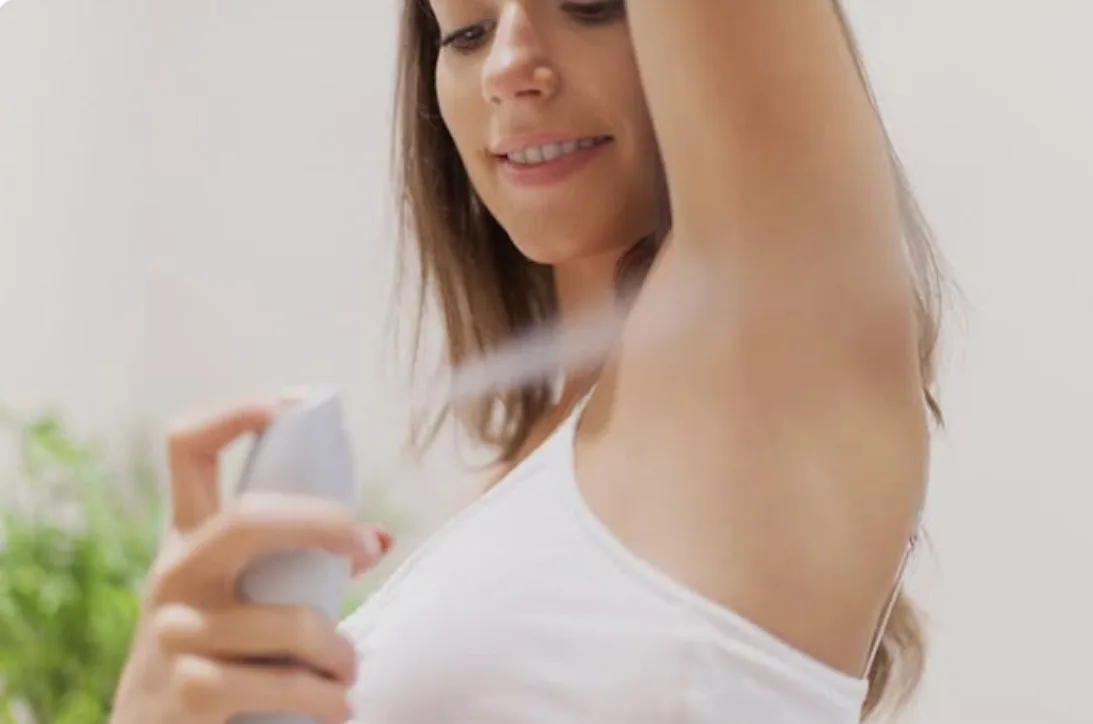 woman checking underarm smell while using deodorant